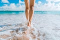 Legs of a beautiful young girl who runs towards the ocean on a sandy beach. Vacation on the Paradise beaches of Asia. Summer and Royalty Free Stock Photo