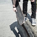 Legs and the board skateboarder at start. Close-up.