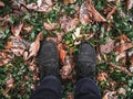 Legs in boots, fallen leaves in the forest Royalty Free Stock Photo