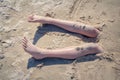 Legs of a boy buried in the sand of a beach Royalty Free Stock Photo