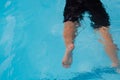 Legs of a boy drowning in the pool. Royalty Free Stock Photo