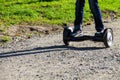 Legs of boy riding on self-balancing mini hoverboard in the city park Royalty Free Stock Photo