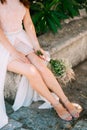 Legs of the bride and bouquet Royalty Free Stock Photo