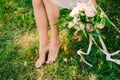 Legs of the bride and bouquet Royalty Free Stock Photo