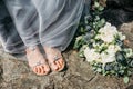 Bride legs and wedding bouquet.