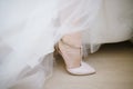 The legs of the bride in a wedding dress in shoes Royalty Free Stock Photo