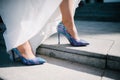 The legs of the bride in a wedding dress in shoes Royalty Free Stock Photo