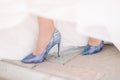 The legs of the bride in a wedding dress in shoes Royalty Free Stock Photo