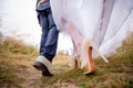 Legs brides and groom, newlyweds walk