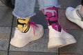 Legs in bright colored socks and white sneakers