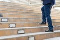 legs of businessman walking stepping up stair in modern city, bu Royalty Free Stock Photo