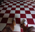 Legs and checkered tiles