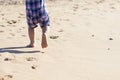 Legs of children stand on the beach. Baby feet in the sand. Summer beach background. Summertime holidays concept. Copy space Royalty Free Stock Photo