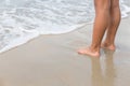 Legs of children stand on the beach Royalty Free Stock Photo