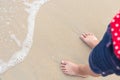 Legs of children stand on the beach Royalty Free Stock Photo