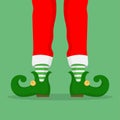 Legs Christmas Elf in green shoes with bells, in striped stockings and in short red breeches