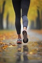 Legs close up. Woman during jogging workout in an autumn city park. Royalty Free Stock Photo