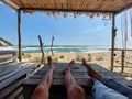 Legs of a couple on a beach table Royalty Free Stock Photo