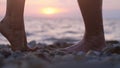 Legs of couple in love during the date near the sea on the beach during beautiful sunset. Royalty Free Stock Photo