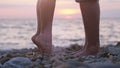 Legs of couple in love during the date near the sea on the beach during beautiful sunset. Royalty Free Stock Photo