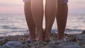 Legs of couple in love during the date near the sea on the beach during beautiful sunset. Royalty Free Stock Photo