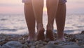 Legs of couple in love near the sea on the beach during beautiful sunset. Royalty Free Stock Photo