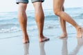 Legs of  couple stand together on beach. Man and woman in love Royalty Free Stock Photo