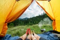 Legs of a couples of man and woman in a tent outdoors