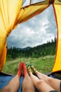 Legs of a couples of man and woman in a tent outdoors