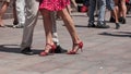 Legs of couples of tango dancers on main place with o