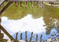 Legs Dangling Down from Wooden Pier over Water Royalty Free Stock Photo