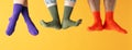 Legs in different socks on yellow background Royalty Free Stock Photo