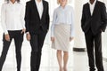 Legs of diverse work managers posing in office hallway