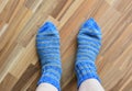 The legs of an elderly person in warm woolen socks. Royalty Free Stock Photo