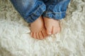 Legs fashionable newborn baby. Little child in jeans sleeping in Royalty Free Stock Photo