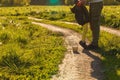 The legs of the father and the child in yellow pants, where the child stands on his toes and on his father`s shoes on the road