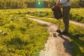 The legs of the father and the child in yellow pants, where the child stands on his toes and on his father`s shoes on the road