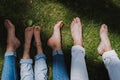 Family with bare feet resting on the grass Royalty Free Stock Photo