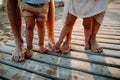 Legs and feet of family standing on beach on summer holiday, a midsection. Royalty Free Stock Photo