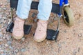 Legs feet handicap woman in wheelchair wheel on road in hospital park waiting for patient services. Unrecognizable paralyzed girl Royalty Free Stock Photo