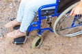 Legs feet handicap woman in wheelchair wheel on road in hospital park waiting for patient services. Unrecognizable paralyzed girl Royalty Free Stock Photo