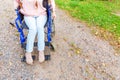 Legs feet handicap woman in wheelchair wheel on road in hospital park waiting for patient services. Unrecognizable paralyzed girl Royalty Free Stock Photo