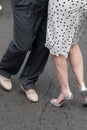 Legs and feet of male and female couple demonstrating dance moves on the street