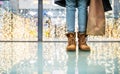 Legs of a woman with bags in shopping center at Christmas time. Royalty Free Stock Photo