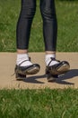 Legs and feet of young girl in black tap shoes, white socks and black tights. Royalty Free Stock Photo