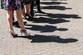 Legs of festive clothed people standing in a row