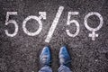 Legs with gender symbol on asphalt Royalty Free Stock Photo