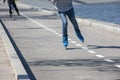 Legs of girl having roller skate exercise along roadline Royalty Free Stock Photo