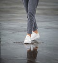 Legs of a girl in rainy weather on the street in the city Royalty Free Stock Photo