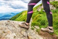 Legs of a girl in mountain boots on a background of beautiful mountains. Close-up. Hiking. Leisure Royalty Free Stock Photo